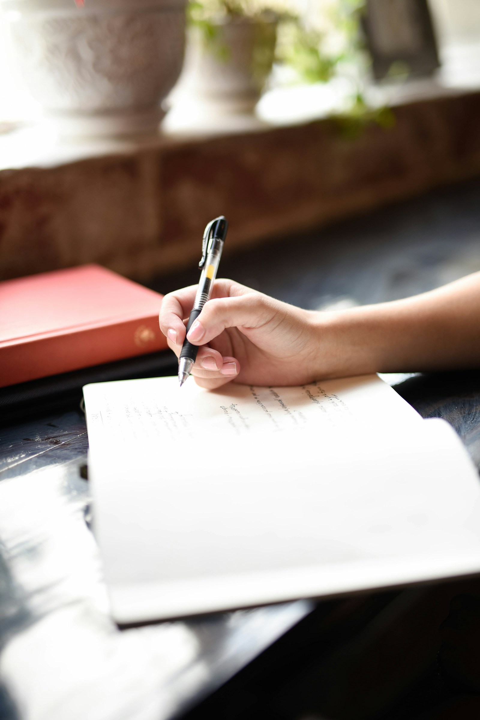 A person writing on a piece of paper